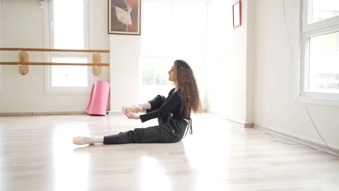 Ballerina doing practice and stretching movements in studio Stock Footage 104700467