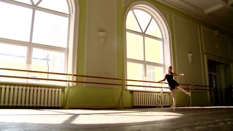 A ballerina is engaged in a training hall by the window Stock-Footage 81236675