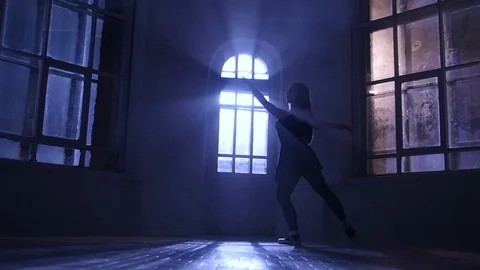 Ballerina girl practicing ballet in studio, moonlight silhouette. Slow motion Stock Footage