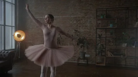 Ballerina graciously posing in a beautiful tutu dress in a contemporary studio Stock Footage 311737966