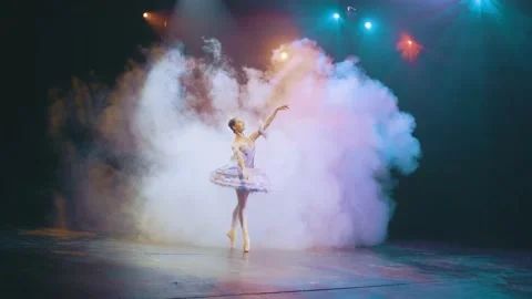 A ballerina performs elements of classical ballet in an empty theater. Smoke Stock Footage 205363414