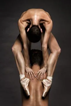 Ballerina in Pointe Shoes, Acrobatic Couple Posing over Gray Background Stock Photos