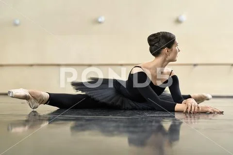 Ballerina Posing In Dance Hall