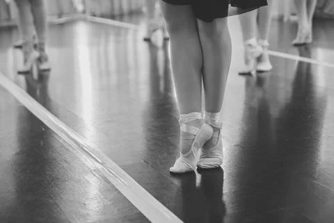 Ballerina practicing ballet steps in studio with monochrome reflections Stock Photos