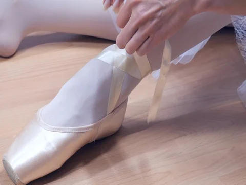 Ballerina puts on pointes Stock Footage 82302750