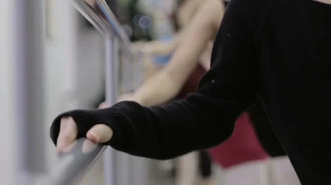 Ballerina warms up at the barre Stock Footage 64907415
