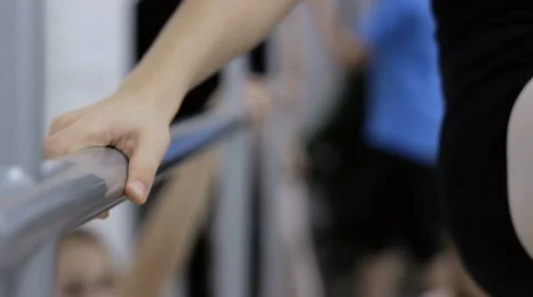 Ballerina warms up at the barre Stock Footage 64908255