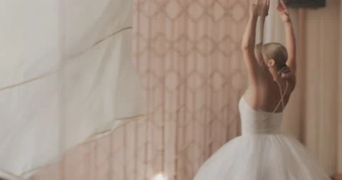 A ballerina in a white ballet suit performs various ballet moves Stock Footage 150984071