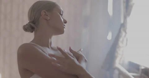 A ballerina in a white ballet suit performs various ballet moves Stock-Footage 150984416