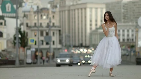 Ballet dancer dances against the background of passing cars 動画素材 79434478