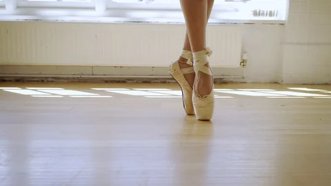 Ballet dancer daning in a light bright dance studio Stock Footage 127584691