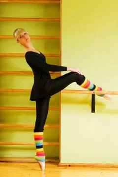 Ballet dancer doing exercise near the bar Stock Photos