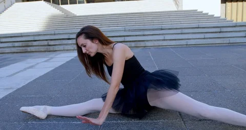 Ballet dancer doing the splits on the pavement 4k Stock Footage 94205786