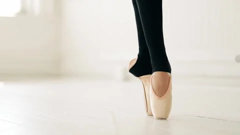 Ballet dancer en pointe in a bright, minimalistic dance studio Stock Footage 303397945