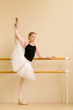 Ballet dancer executing high leg extension Stock Photos