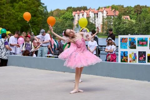Ballet dancer performing outdoors during colorful community festival Stock Photos