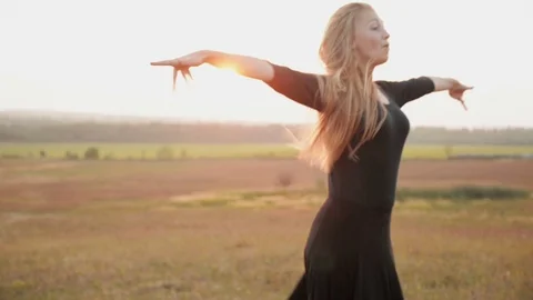 Ballet dancer posing during the sunset, silhouette concept Stock Footage