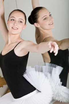 A ballet dancer posing next to a mirror in a ballet studio Stock Photos