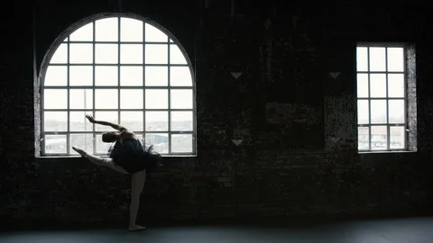 Ballet dancer stretches and practices in window 3 Stock Footage 127567601