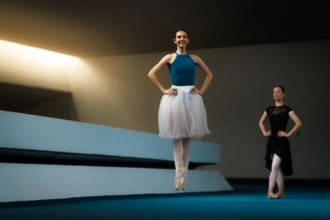 Ballet dancer in tutu practicing on pointe in a modern dance studio with Stock Photos