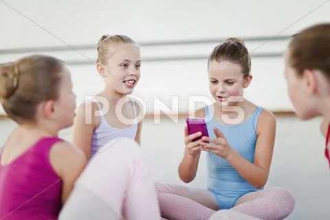 Ballet Dancer Using Cell Phone In Studio