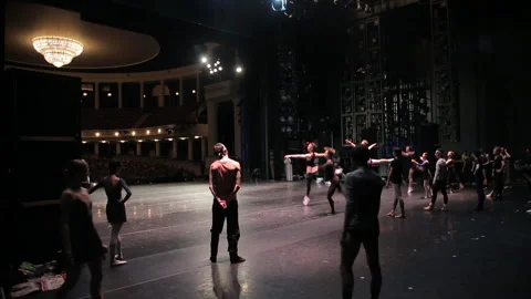 Ballet dancers are practicing jumps on a stage very long shot Stock Footage 93823800