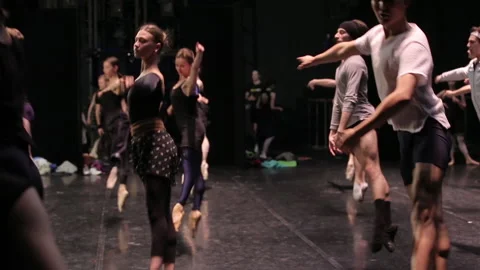 Ballet dancers are practicing jumps on a stage long shot Stock Footage 93823810