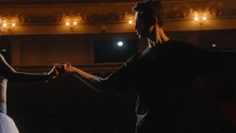 Ballet dancers perform ballet movements on theater stage Stock Footage 238075768