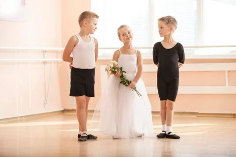 At ballet dancing class: young boys and a girl with flowers Stock Photos