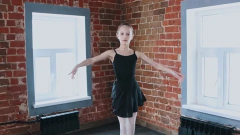 Ballet dancing indoors - a little gymnastics girl dancing in black suit on Stock Footage 154137818