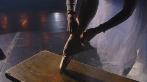 Ballet female dancer ties pointe shoes Stock Footage 238070355