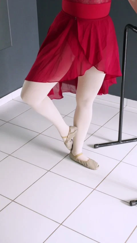 Ballet student performing coupé and passé beside the barre. Video stock 322851262