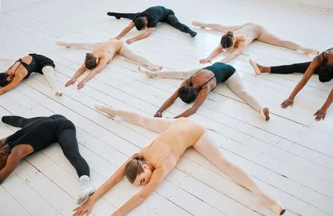 .Ballet, students and leg stretching floor together for balance, exercise and Stock Photos