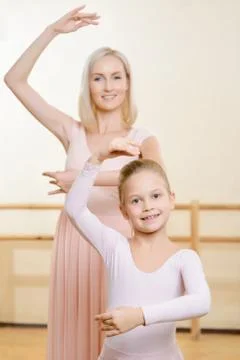 Ballet teacher and her apprentice are holding a pose Stock Photos