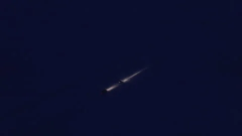 Ballistic missile flying through the dark night sky Stock Footage 337037870