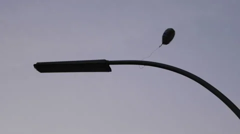 Ballon hanging on a traffic light Stock Footage 58495744