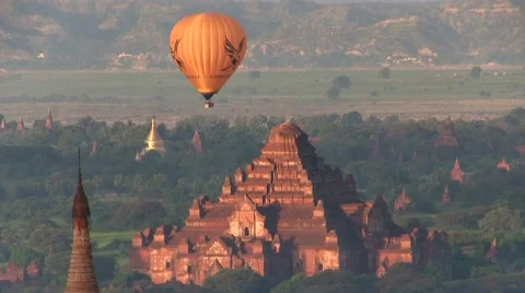 Ballons at sunrise flying over Bagan Myanmar, Asia Stock Footage