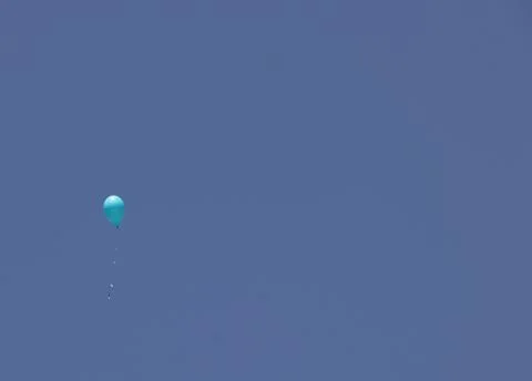A balloon on a blue sky background Stock Photos