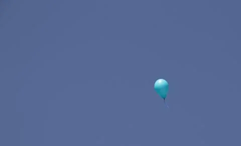 A balloon on a blue sky background Stock Photos