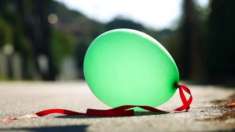 Balloon bursting on the road Stock Footage 221744555