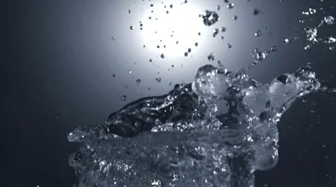 A balloon filled with water bursts in slow motion. Stock Footage