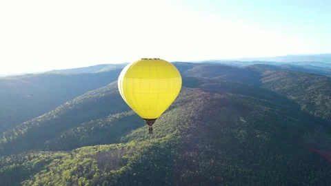 A balloon flies over the mountains Stock Footage 153986977