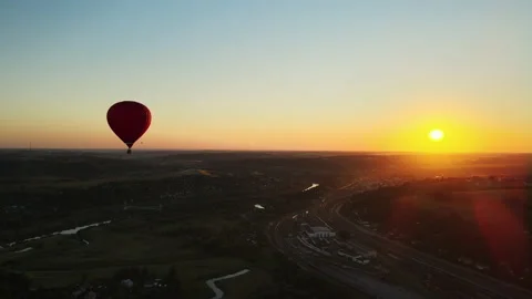 Balloon flight over the city and river at sunset Stock Footage 167391897