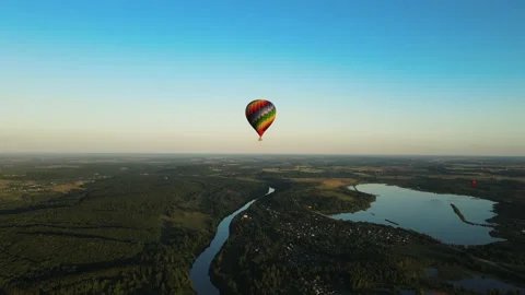 Balloon flight over the city and river at sunset Stock Footage 167394801