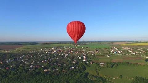 A balloon is flying over the ground Stock Footage 85510817