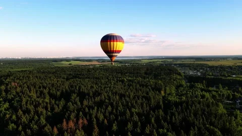 The balloon is gaining altitude, flying over the forest Stock Footage 205722346