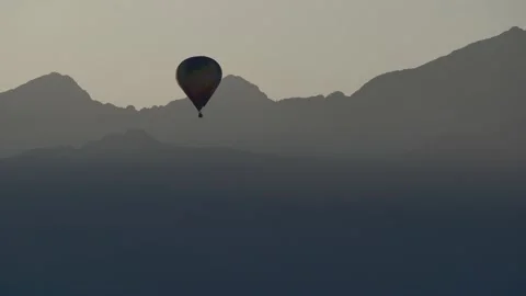 The balloon goes up. Line of mountains. Multi-colored ball. Mountains in the Stock Footage 145555289