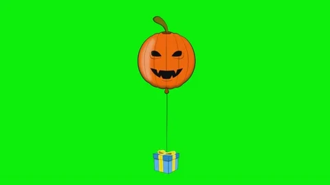 A balloon with halloween pumpkin on it and an orange face hanging from ' s Stock Footage 345497053