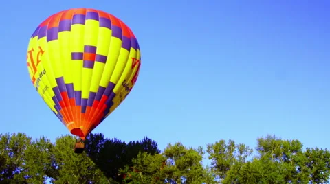 Balloon hops over trees Stock Footage 56574240