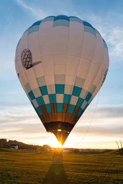 Balloon landing in sunset Stock Photos